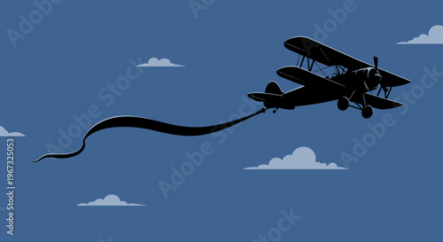 Biplane flying with banner in the blue sky.