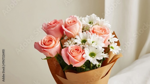 Flower Bouquet With Pink Roses and White Daisies in Brown Wrapping on a Table