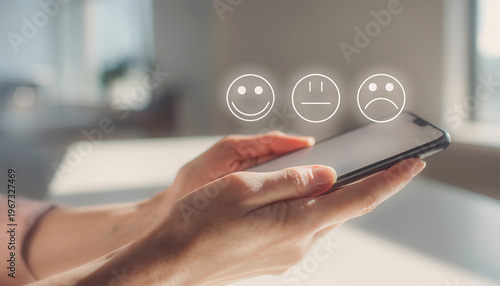 Hands Holding Smartphone with Happy Neutral and Sad Emojis Floating Above