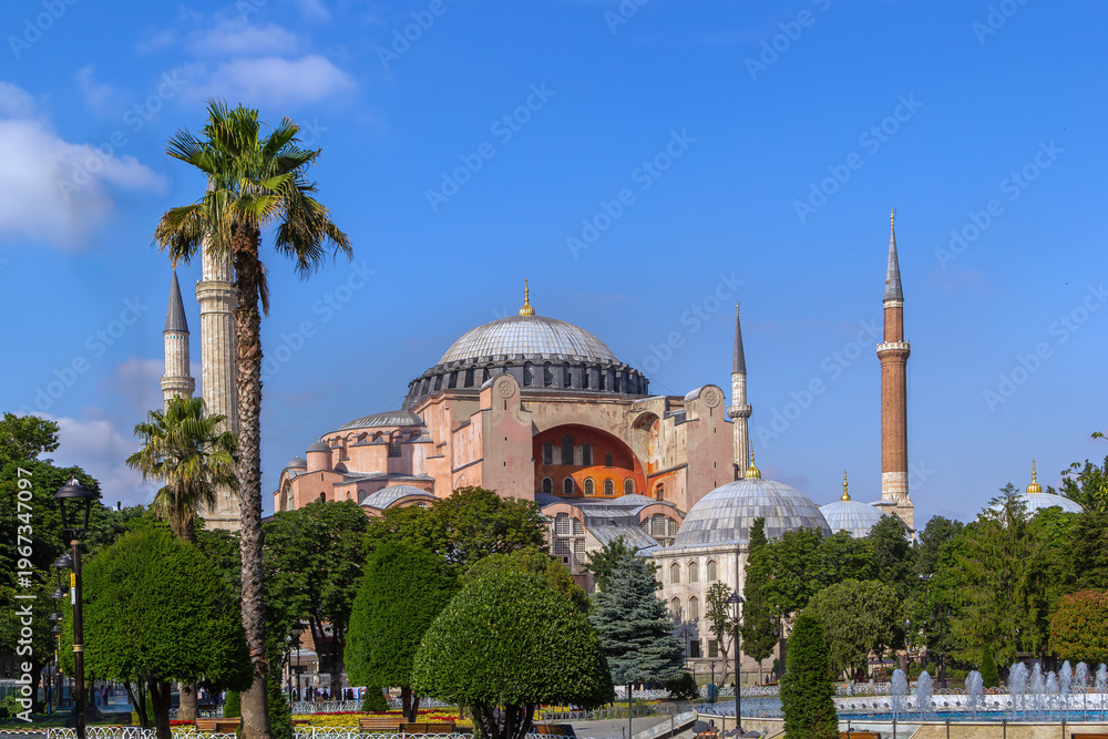 Naklejka premium Hagia Sophia Mosque view from Sultanahmet Square in Istanbul, Turkey. Byzantine architecture with domes under sunny blue sky