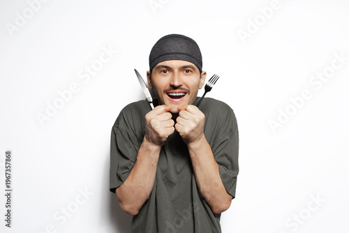 Happy man with knife and fork in hands isolated on white background. Surprised gesture.