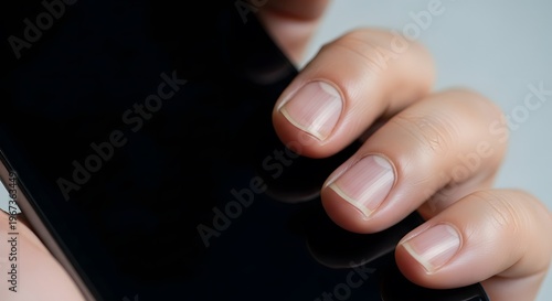 Close-up of Person Using Smartphone with Focus on Fingers.