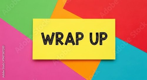 Wrap Up text on yellow card, colorful paper background in flat lay style, business summary and project conclusion concept