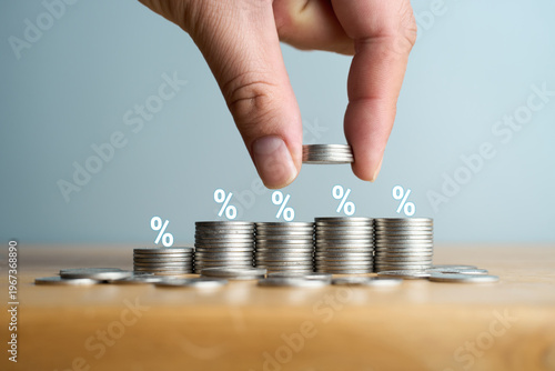 Canvas-taulu Hand stacking coins with percentage icons representing rising interest rates and