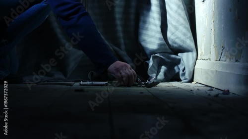 Addict cutting illegal drugs in dark room