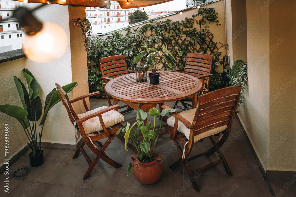 Obraz premium A rooftop terrace decorated with tropical wood furniture and plants, ready for warmer weather. Interiors, decor, lifestyle