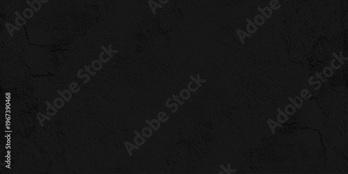 Black concrete wall texture background with subtle cracks and stone grain, dark cement plaster surface for backdrop