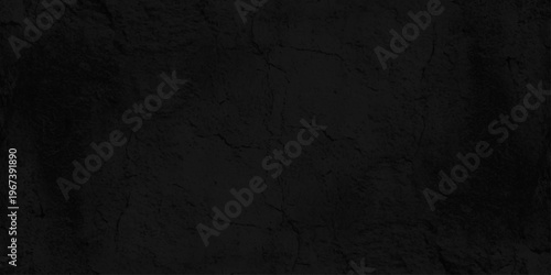 Black concrete wall texture background with subtle cracks and stone grain, dark cement plaster surface for backdrop