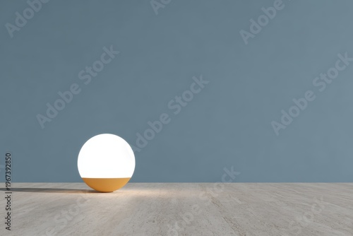 An eggshaped table lamp sitting atop a wooden table with a wall in the background. the lamp is white and yellow in color giving it a warm and inviting glow.