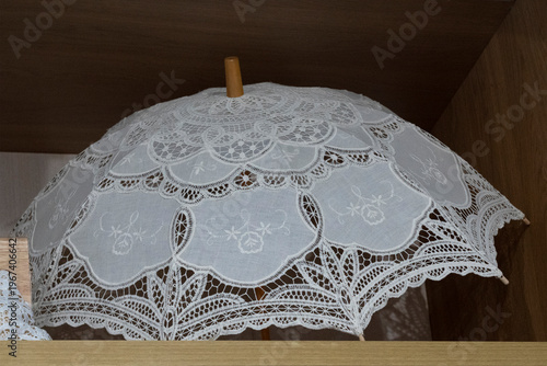 White lace umbrella for sun protection, hot weather concept and traditional souvenir