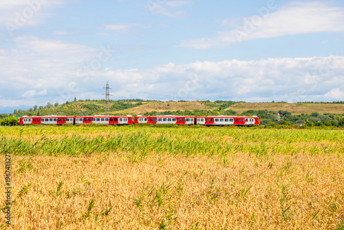 Fotografía Rural Romanian landscape with a train passing through