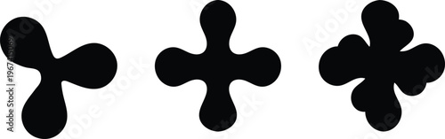 Abstract black inkblot shapes a rorschach like composition of three unique organic forms on white background