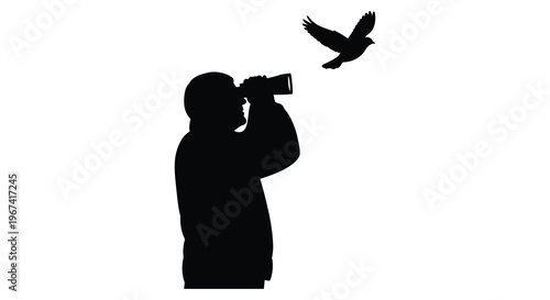 Birdwatcher with binoculars observes a soaring bird dark silhouette