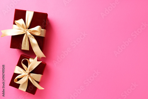 Beautiful red gift boxes on pink background, top view. Space for text