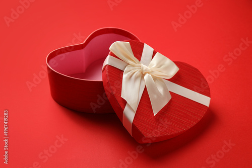 Beautiful heart shaped box on red background, closeup