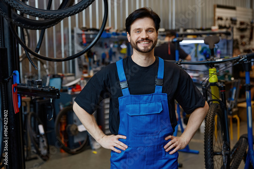 Skilled technician with bright smile at repair shop