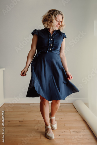 Woman walking in elegant dress full body portrait indoors