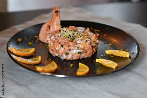 Fresh salmon tartare with shrimp citrus garnish gourmet seafood plate