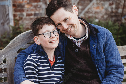 Father and son close portrait smiling together outdoors