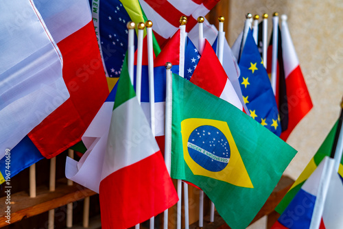 Canvas Print Small national flags on sticks, Brazil, Italy, European Union, Poland, international symbols for travel and tourism, colorful patriotic background, close-up of world flags at sports or cultural event