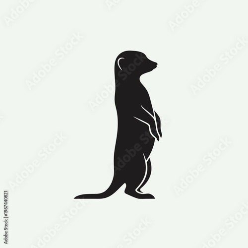 Silhouette of a meerkat standing upright observing its surroundings with vigilance and curiosity.