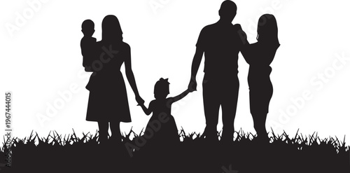 Silhouette of a family with four members in a grassy field