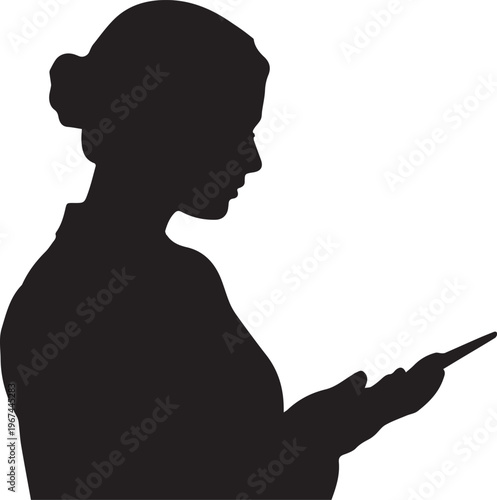 Silhouette of a woman with hair in a bun looking at a tablet