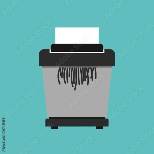 Paper shredder with shredded paper office equipment for document destruction security and privacy.