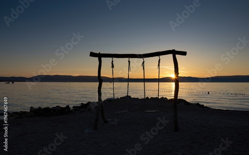 Swing on the beach in sunset