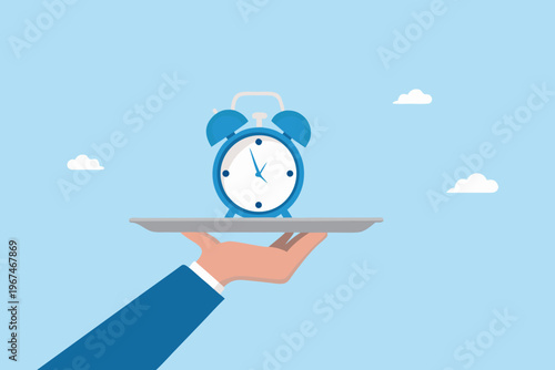 A blue alarm clock is presented on a silver platter by a hand