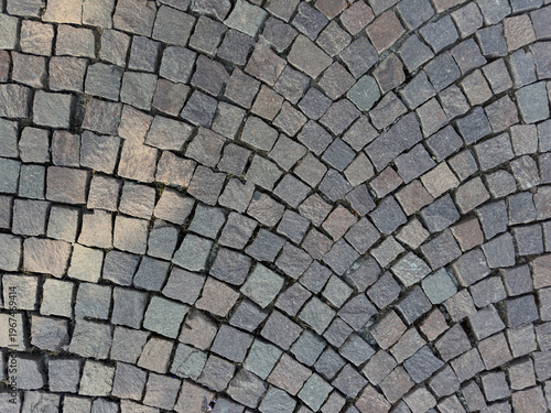 Fotografija Traditional Porphyry Cobblestone Pavement with Fan Pattern Patterned Street Text