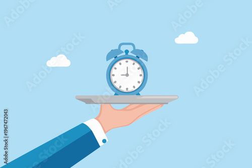 A blue alarm clock presented on a silver platter by a hand