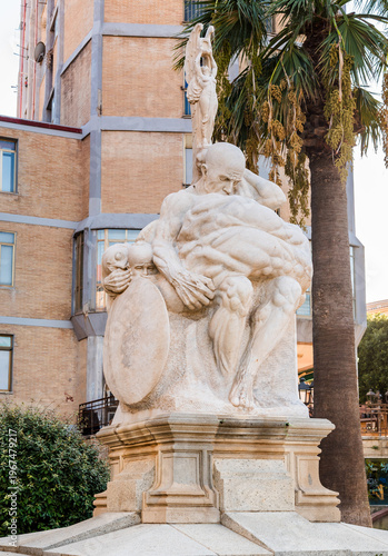 Wallpaper Mural Monument to the Fallen of Sardinia located in Piazza Guglielmo Oberdan in the town of Iglesias, Sardinia, Italy. War memorial and historic monument in a public square. Torontodigital.ca
