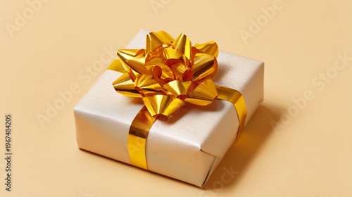 Gift Wrapped With Golden Bow on Light Background
