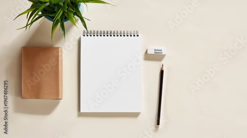 Notebook and Pencil With a Plant and a Card on a Desk During the School Season