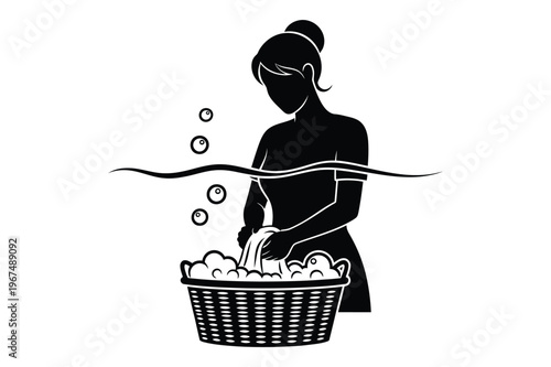 Woman hand washing clothes in basket with bubbles