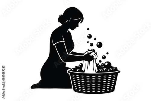 Silhouette of a woman washing clothes in a basket