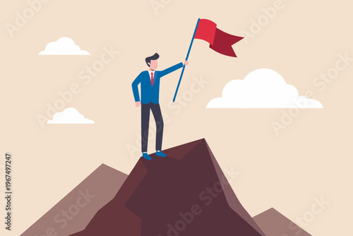 A businessman proudly plants a red flag atop a mountainous peak