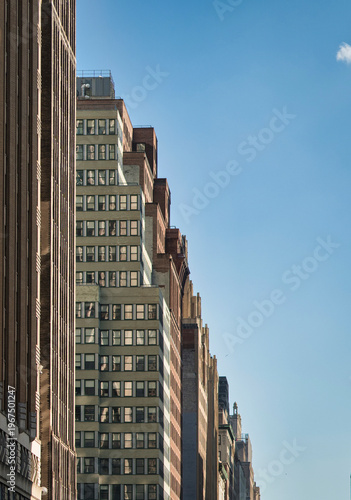 Manhattan architectural facades under a clear blue sky in New York City