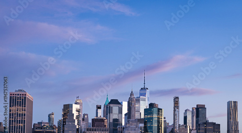 New York City skyline at dusk featuring One World Trade Center and Lower Manhattan