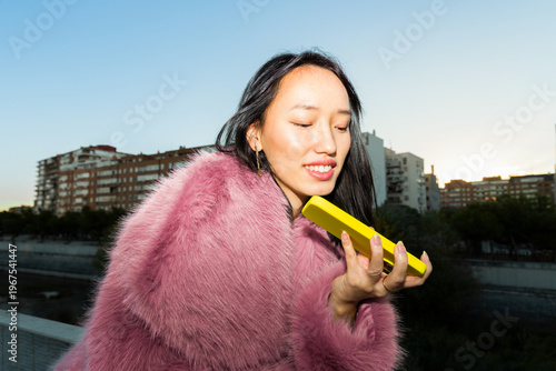 Asian woman enjoying urban lifestyle with smartphone