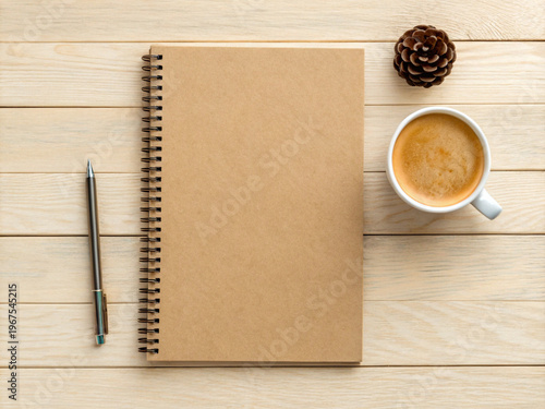 Kraft Spiral Notebook with Coffee Cup and Pen Flat Lay on Natural Wooden Surface