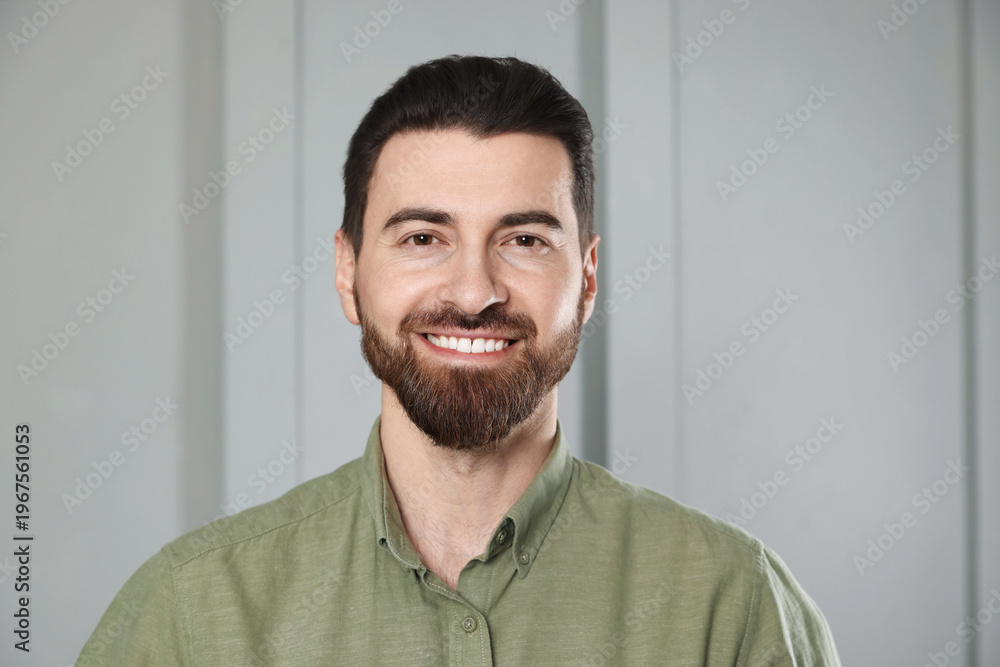 Fototapeta premium Portrait of handsome man near white wall indoors