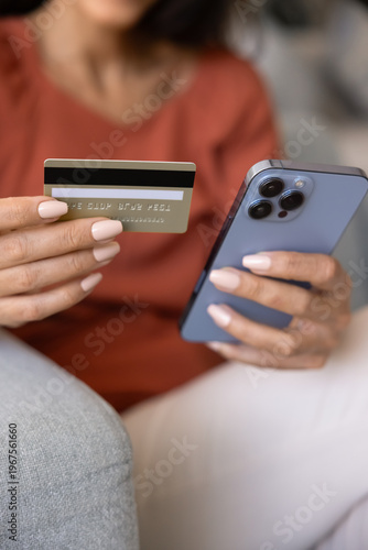 Foto Close up hands holding mobile phone and credit card