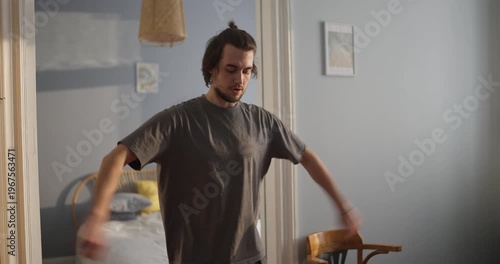 a young man stretches, embracing the morning's calm and fluidity through graceful movements