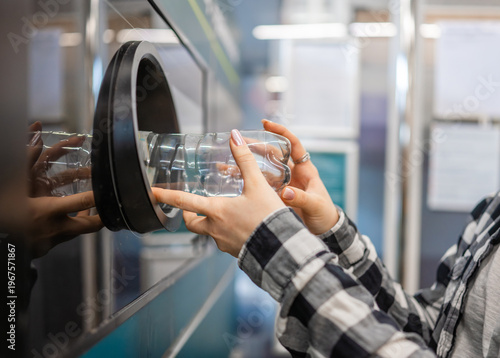 Obraz na plátně Girl Is Returning Empty Plastic Bottles In Machine