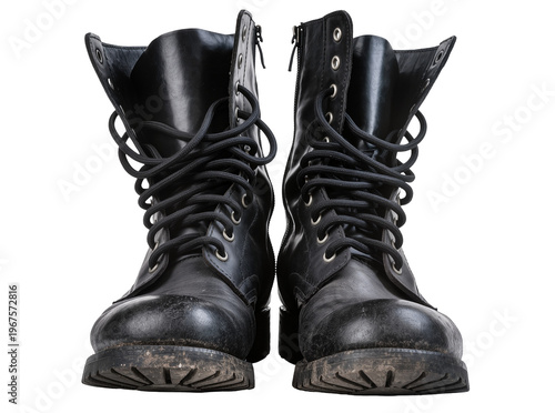 Isolated pair of worn black leather lace-up combat boots with rugged dirty soles and zippers