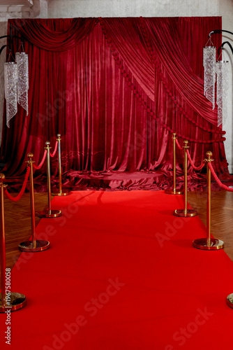 Red carpet event setup with velvet backdrop and stanchions in venue