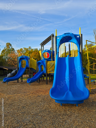Early evening view of the colorful slides on a children's playground set in a Twinsburg Ohio city park