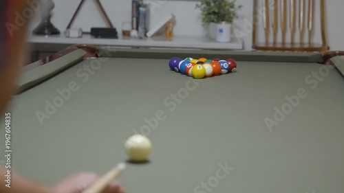 Close-up of a Man Playing Billiards and Pocketing a Ball